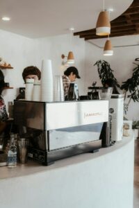 a coffee shop counter with a coffee maker on top of it